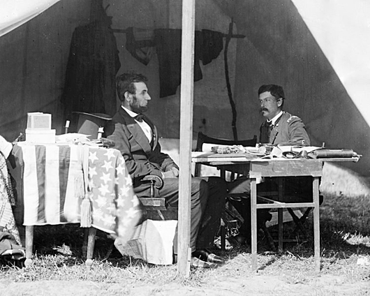Abraham Lincoln and Gen. George B. McClellan at Antietam, Maryland, Oct. 3, 1862. Lincoln's hat is visible on a table. An Alexander Gardner photograph, courtesy Wikipedia Commons.