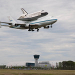 Space shuttle Discovery, mounted atop a NASA 747 Shuttle Carrier Aircraft (SCA) flies over the Steven F. Udvar-Hazy Center, Tuesday, April 17, 2012, in Washington. Discovery, the first orbiter retired from NASA’s shuttle fleet, completed 39 missions, spent 365 days in space, orbited the Earth 5,830 times, and traveled 148,221,675 miles. NASA has transferred Discovery to the National Air and Space Museum to begin its new mission to commemorate past achievements in space and to educate and inspire future generations of explorers. Photo Credit: (NASA/Smithsonian Institution/Dane Penland)