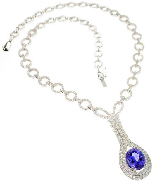 14K white gold necklace mounted with genuine 4-carat tanzanite surrounded by 82 round faceted diamonds and an additional 300 diamonds encrusted on the chain. Valued at $23,000-$46,000. Government Auction image.