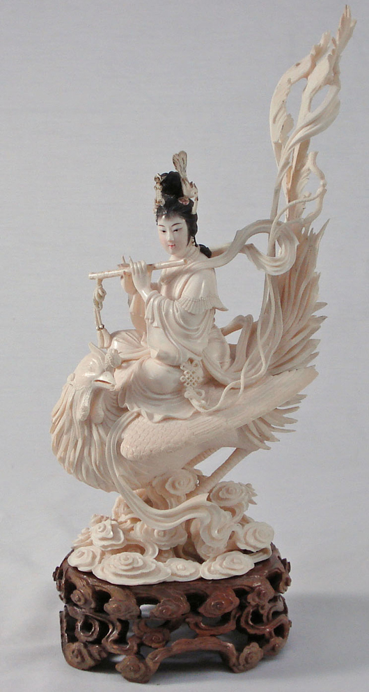 Carved ivory phoenix carrying a flutist. Image courtesy of Shelley's.