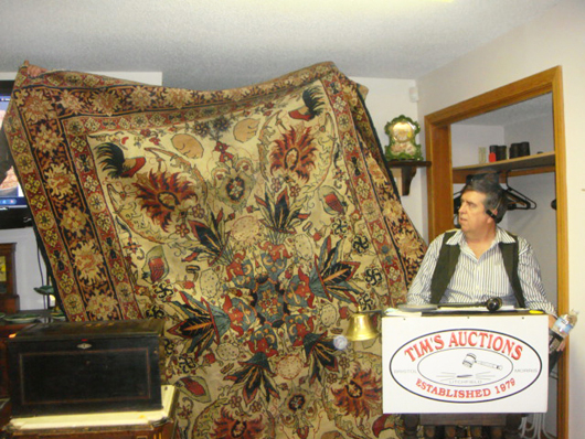 Auctioneer Tim Chapulis is dwarfed by this gorgeous Kerman carpet that hammered $4,425. Image courtesy Tim's, Inc.