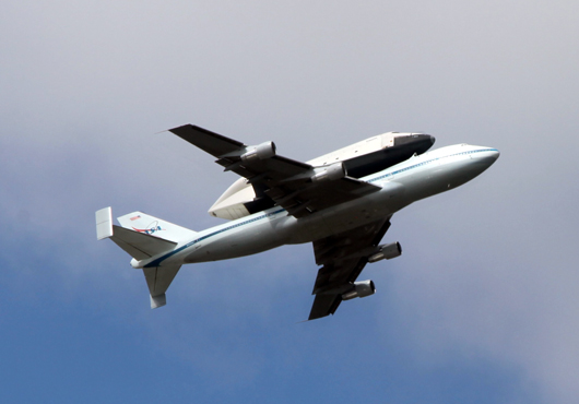 A Shuttle Carrier Aircraft, or SCA, flies over New York City carrying the Space Shuttle Enterprise to its final destination in April 2012. Photo by Tiffany Moy.