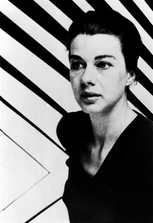 Bridget Riley in front of Continuum, 1963. (Photographer unknown). Ms Riley's new joint exhibition at the London galleries of Hazliitt Holland & Hibbert and Karsten Schubert opens on 23 May. Image courtesy Bridget Riley studio.