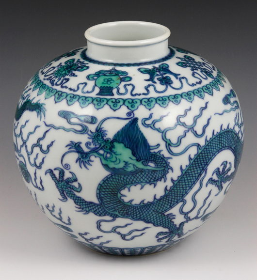 Doucai jar, China, painted with blue and green dragons chasing pearls amidst clouds with a ruyi pattern above, Qianlong mark on base, est. $3,000-$5,000.