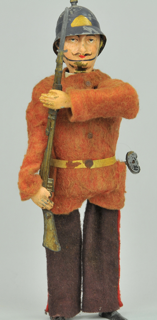 Fernand Martin cloth-dressed tin wind-up English soldier with metal helmet and gun, French, $6,325. Bertoia Auctions image.