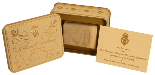 A slice of Prince William and Catherine Middleton's wedding cake in presentation tin, with printed ‘compliments’ slip from TRH The Prince of Wales and The Duchess of Cornwall. PFC Auctions image.