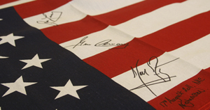 American Flag signed by astronauts Neil Armstrong, Jim Lovell and Gene Cernan on a recent trip to Afghanistan. PFC Auctions image.