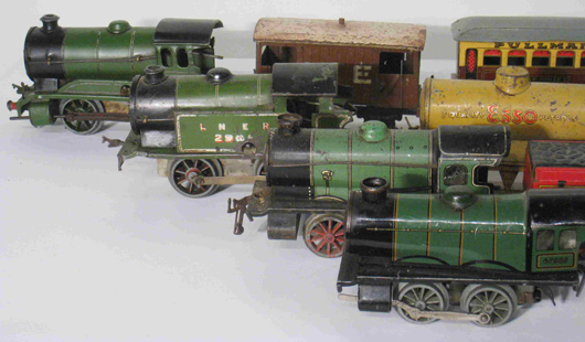 Group of Hornby-type trains, including four windup lithographic decorated locomotives. Image courtesy Gordon S. Converse & Co.   