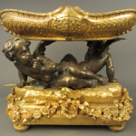 Dore and patinated bronze putti centerpiece, French, 19th century, est. $6,000-$8,000. Sterling Associates image.