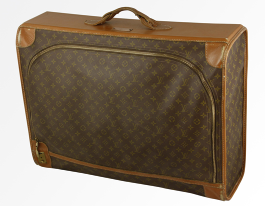Louis Vuitton soft-sided luggage bag, ‘Manufactured by the French Co. USA under special license’ to Saks Fifth Avenue, circa 1960s, 22 inches high x 28 1/2 inches wide x 9 inches deep. Some surface wear at corners. Estimate: $200-$400. 