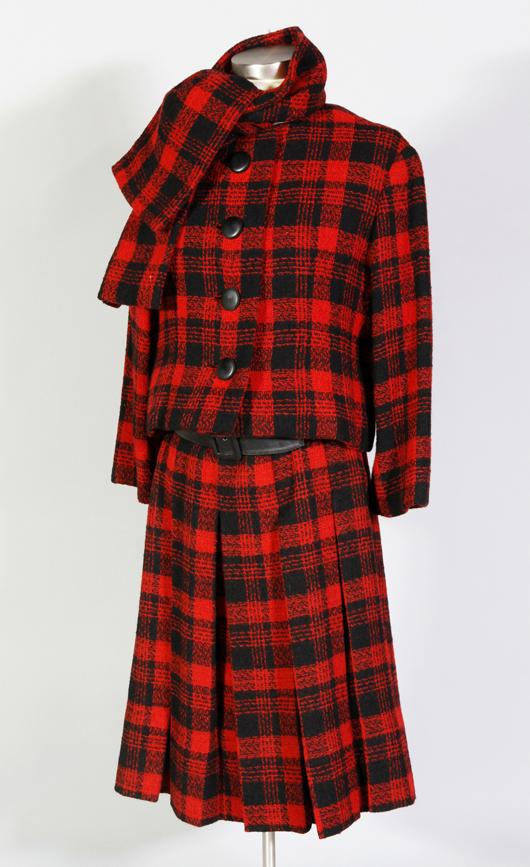 Christian Dior New York sleeveless dress with pleated skirt, cropped jacket and scarf, all matching red and black plaid wool with black satin lining inside body of dress and jacket, matching black belt, zipper closure at back of dress, button closure on jacket, women's size 8. Owner worked for Christian Dior New York 1959-1962 as receptionist and in-house model, purchased 1960/1961. Estimate: $200-$300. Image courtesy Kaminski Auctions.   
