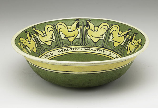 Important Saturday Evening Girls center bowl decorated with roosters and motto. Estimate: $17,500-$22,500. Image courtesy Rago Arts and Auction Center.   