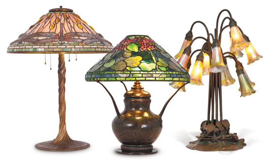 Tiffany Studios lamps (from left) leaded glass Dragonfly lamp, leaded Favrile Geranium lamp and 12-light Lily lamp. Image courtesy Abell Auction Co.   