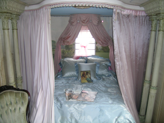 Fit for a queen, Elizabeth Taylor's bed inside the dressing room/trailer. Image courtesy Premiere Props.