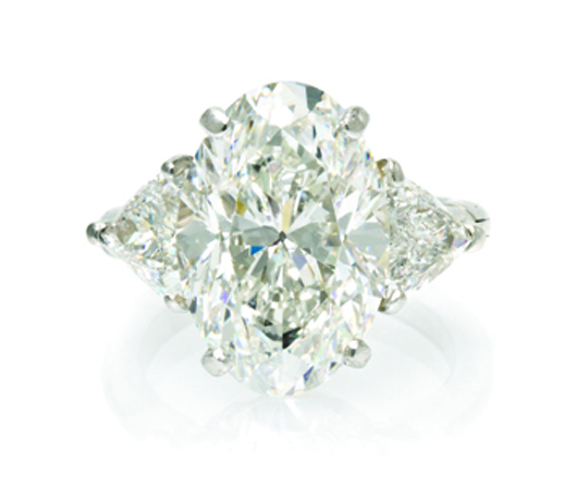 Oval 7.06-carat brilliant cut diamond ring with two triangular cut diamonds: $146,400. Leslie Hindman Auctioneers image.