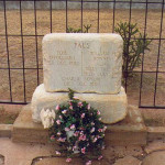 Outlaw Billy the Kid's tombstone was pushed off its base. Image courtesy Wikimedia Commons.