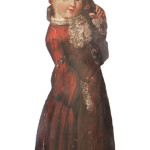 This dummy board is a little girl holding a bird in her hand. She is dressed in 17th-century style. A hinged board that is nailed to the back helps her stand up. It sold at an auction in New York in the 1960s for $100 and has been in a hall corner ever since.