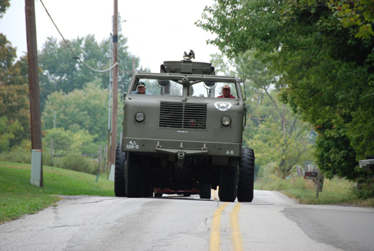 Dave Morrison, in the passenger seat, leaves the driving to truck driver friend Doug Banks. The 11-foot-wide M26 tank retriever extends over the center line. Image submitted.