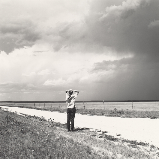 Robert Adams, American, born 1937, Kerstin enjoying the wind, East of Keota, Colorado,' 1969, gelatin silver print, 7 1/2 x 7 1/2 inches, National Gallery of Art, Washington, Pepita Milmore Memorial Fund and Gift of Robert and Kerstin Adams.