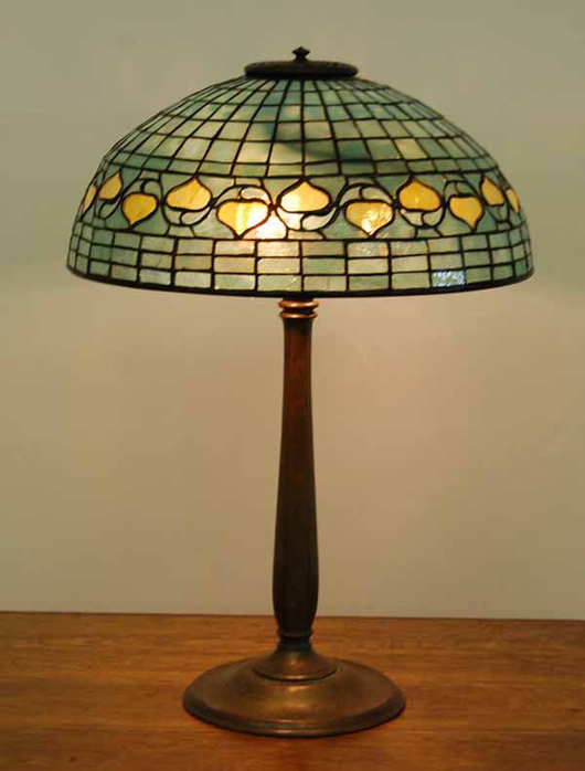 Signed Tiffany Studios Acorn table lamp, 16-inch shade with a signed bronze stick base and bronze heat cap. Estimate: $10,000-$20,000. Blanchard’s Auction Service image.