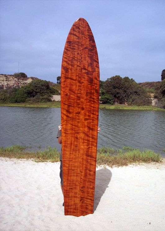 1930 replica curly redwood plank surfboard. Crafted in the late 1970s, this surfboard was shaped using two planks, which were then glued and doweled. Estimate: $8,000-$10,000. Waverider Auctions image.