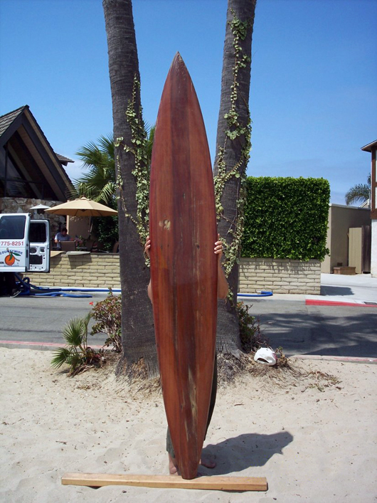 1950s Dale Velzy redwood surfboard, v-shape tail. Original size was 10 feet long by 8 inches wide. It was then cut down, reshaped and glassed by Velzy himself in the 1980s. Estimate: $8,000-$10,000. Waverider Auctions image.