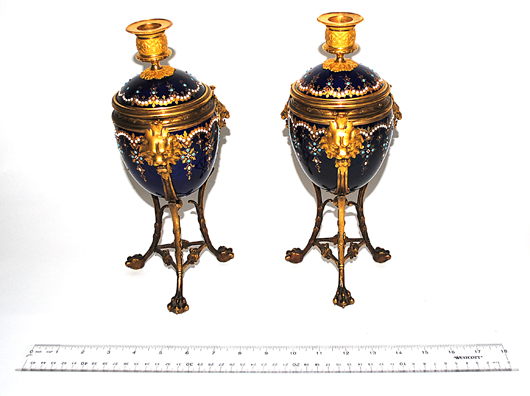 Pair of bronze and enamel urn-form candleholders. Roland Auction image.