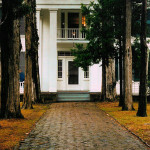 Front walk and entrance of Rowan Oak, the home of Nobel laureate and American novelist William Faulkner in Oxford, Mississippi. It is now owned and maintained by the University of Mississippi as a museum. One of the oldest structures in Oxford, this Greek Revival house on Old Taylor Road was built in the 1840s by a Colonel Shegog. Faulkner bought the crumbling house, then known as the “Bailey Place,” in 1930. He promptly renamed it and slowly refurbished the property. Faulkner’s daughter sold Rowan Oak to the university in 1972. It is a National Historic Landmark. Photo by Gary Bridgman, licensed under the Creative Commons Attribution 2.5 Generic license.