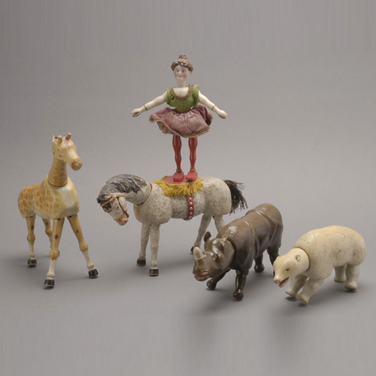 Schoenhut Circus grouping including Buffalo Bill, rhino, zebra, polar bear, two clowns, two donkeys, giraffe, two horses and one female rider; est. $800-$1,200. Michaan's image.