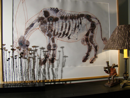 Stylized rendering of a horse by Cuban artist Carlos Estevez; at left front is a sculpture fashioned from African money.
