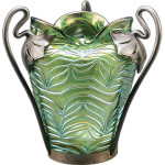 The pewter mounting with the mark of the Van Houten company helps identify this iridescent glass vase. Loetz and Kralik both used Van Houten pewter after 1890. Neal Auction's experts in New Orleans could say only that the 7 1/2-inch-high vase was 'Continental.' Because of its quality, it auctioned for $854.