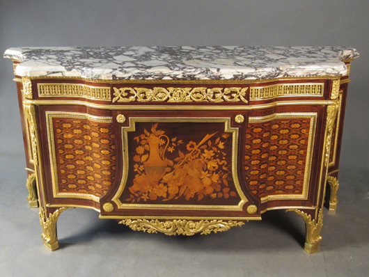 19th-century French marble-top commode with marquetry, parquetry and dore bronze mountings; after the model of the commode “de Fontainebleau” by Riesner. Sterling Associates image.