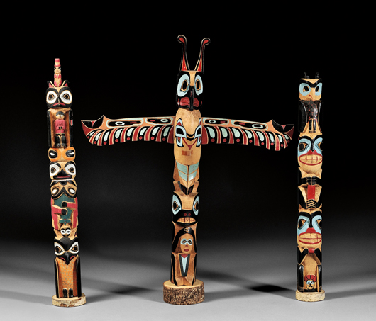Three polychrome carved wood totem poles, 27 1/2 inches high. Provenance: The Bear Totem Store. Estimate:$600-$800. Skinner Inc. image.
