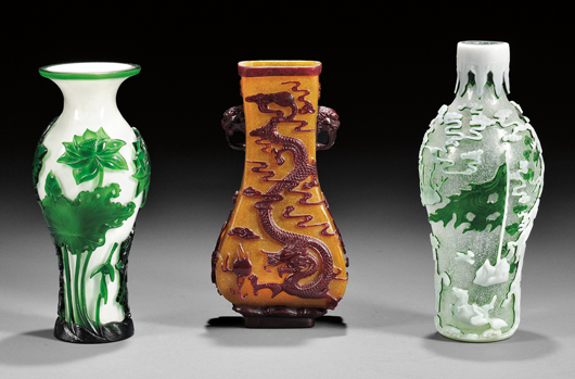 Peking Glass vase (center), China, 18th/19th century, maroon overlay carved through to a yellow snowflake ground, four-character Qianlong mark on recessed base, 8 1/4 inches high. Estimate: $2,000-$4,000. Peking Glass vase (right), 18th/19th century, baluster shape, white and green overlay carved through to a snowflake ground, four-character Qianlong mark on base, 9 1/8 inches high. Estimate: $4,000-$6,000. Skinner Inc. image.
