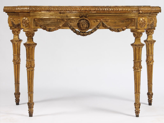 Eighteenth century Italian giltwood carved console table having banded and bookmatched veneered marble top. Image courtesy Kamelot Auctions. 