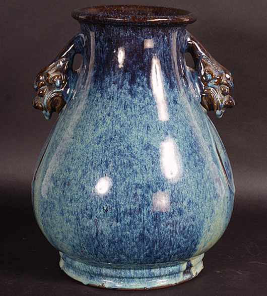 Chinese stoneware vase with deco-style foo dog head handles, circa 1900. Image courtesy Kamelot Auctions. 