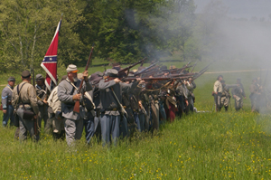 Confederate re-enactors fire their rifles during a re-enactment. This file is licensed under the Creative Commons Attribution-Share Alike 3.0 Unported license.