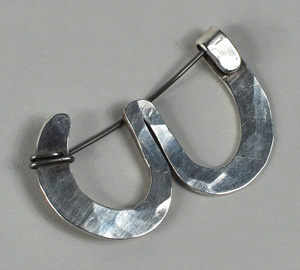 This Alexander Calder hand-hammered sterling silver brooch topped the auction, selling for $22,140. Woodbury Auction image.