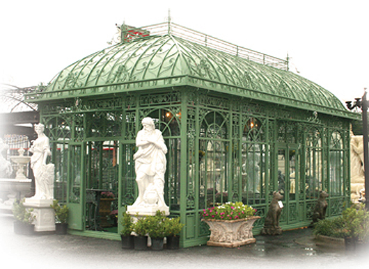 Large-size green wrought iron solarium with tempered glass and detailed scrollwork decoration. Red Baron’s Private Reserve image.