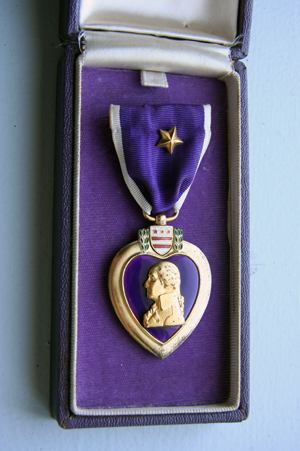Purple Heart in presentation case, awarded to a United States Army soldier in World War II. Photo by Jonathunder, available under the Creative Commons CC0 1.0 Universal Public Domain Dedication.