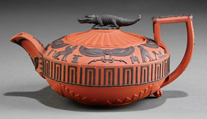 Wedgwood applied Egyptian designs in relief to their dry rosso antico body. This early 19th century red and black teapot – complete with crocodile finial – sold for $2,151. Courtesy Neal Auction Co.