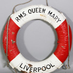 RMS Queen Mary, Liverpool life ring, red and white painted, circa 1950s, 29 inches diameter. Kaminski Auctions image.