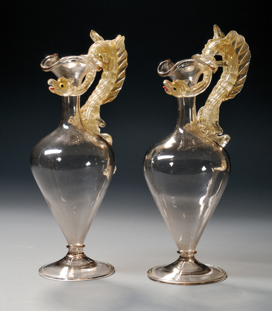 Pair of Venetian colorless blown and gold fleck art glass ewers, 15 1/8 inches high. Estimate: $200-$300. Skinner Inc. image.