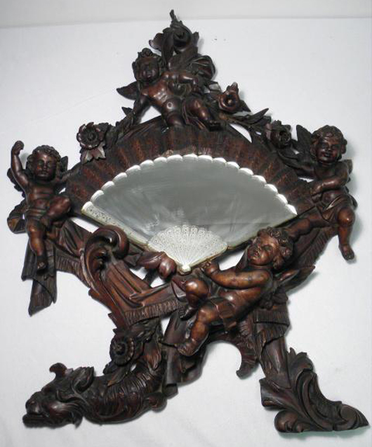 Rococo-style carved walnut mirror with putti, est. 400-$600. Auctions Neapolitan image.