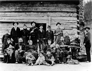 Family photo of the Hatfield clan, including guns and family dog, taken in 1897.