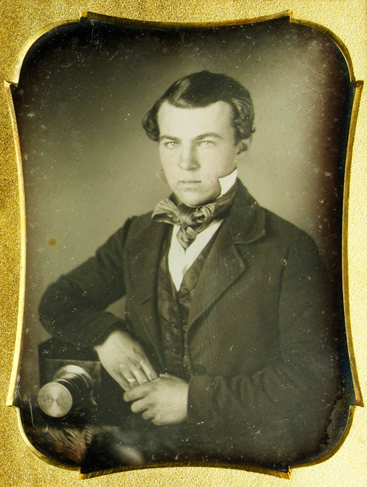 Daguerreotype, one-fourth plate, of a young photographer sitting beside his camera, full leather case, 4 1/2 inches high. Price realized: $17,550. Kaminski Auctions image.