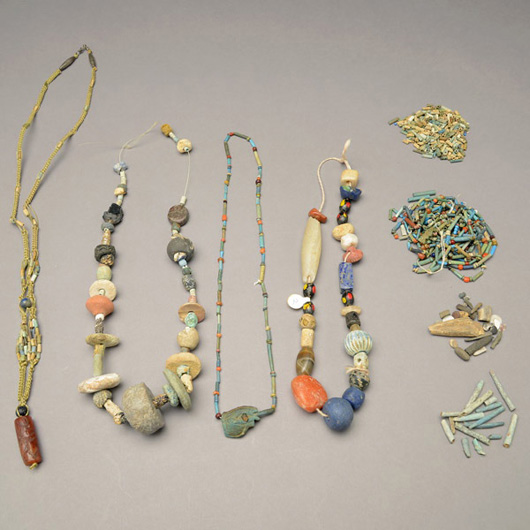 Collection of ancient beads including Afghani, Syria, Islamic and Egyptian faience beads, est. $400-$600. Michaan's image.