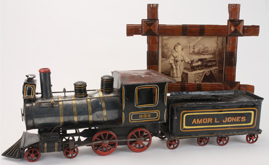 Folk art 999 ‘Amor L Jones’ loco and tender, mixed metals, offered with framed photograph of a little girl for whom the train may have been created. Noel Barrett Auctions image.