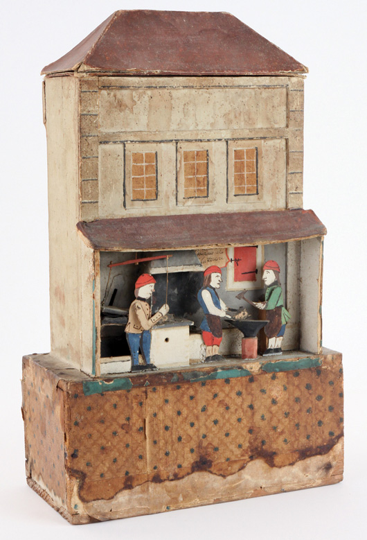 French mechanical sand toy, French Revolutionary era, depicting a forge with blacksmiths pounding on royals’ heads to ‘restyle’ them, per translation of description on paper label. Signed and dated on verso: ‘Jean de Ste. Croix de Lauze – 1791,’ est. $6,000-$8,000. Noel Barrett Auctions image.