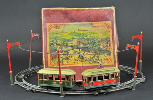 Boxed Carette trolleys with track poles and original box lid, each car 6 ¼ inches long, est. $3,000-$3,500. Bertoia Auctions image.